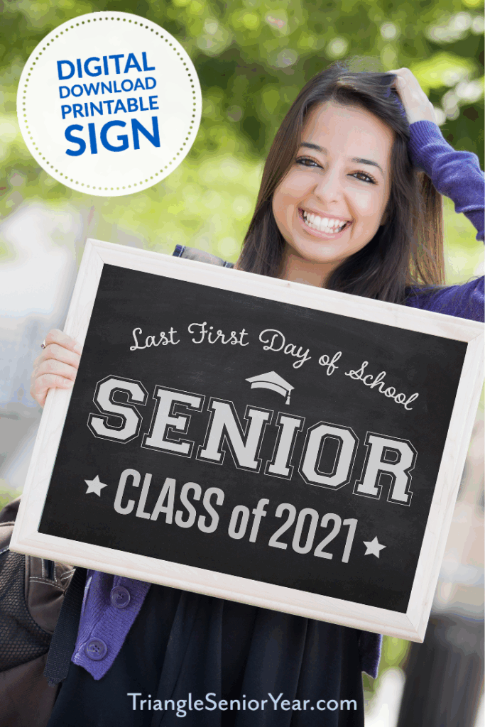 A Woman Holding A Sign That Says First Day Of School Senior Class Of 2021